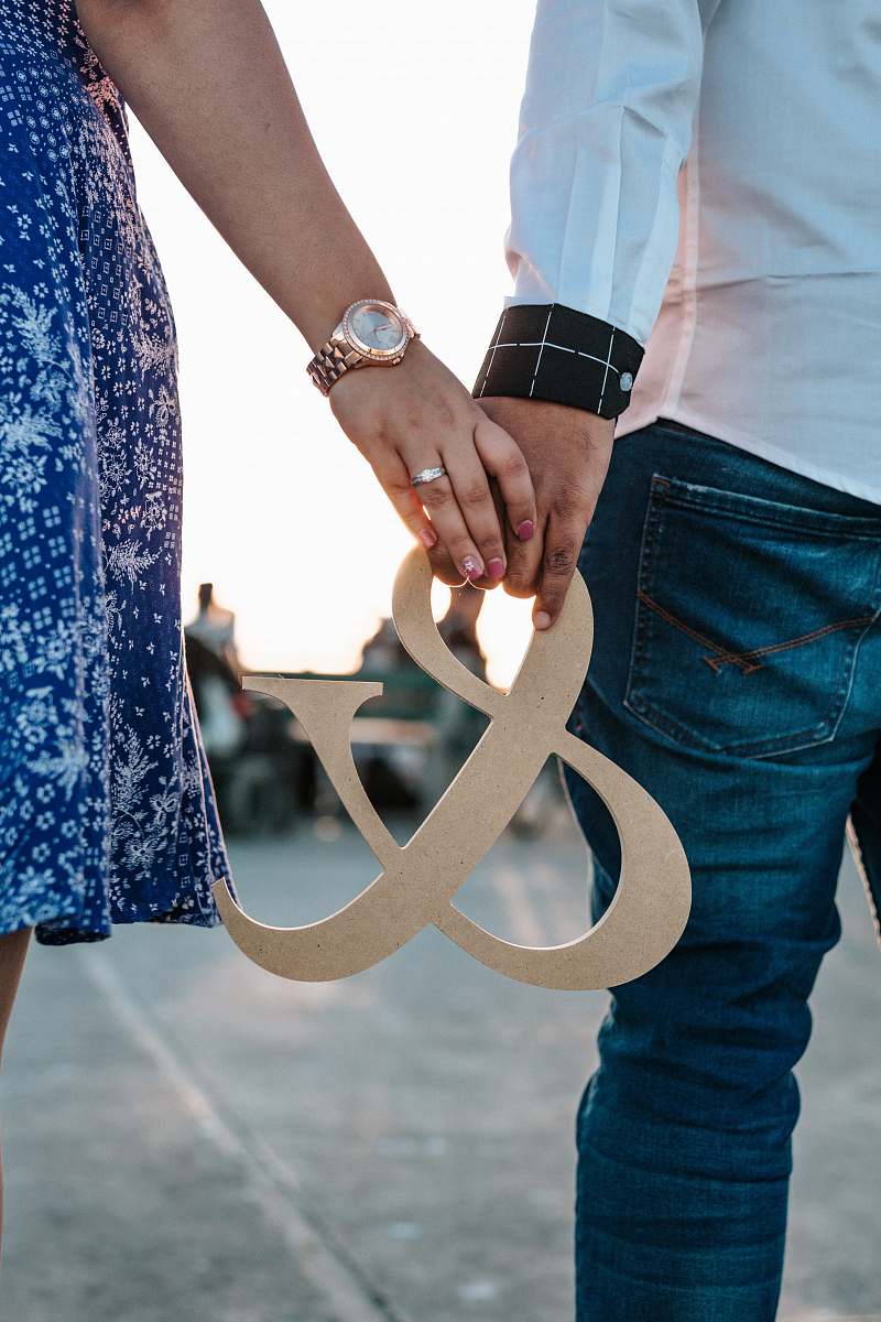 holding hands man and woman holding ampersand decoration flip-flop